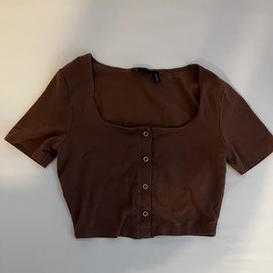 tight brown short sleeve top with buttons